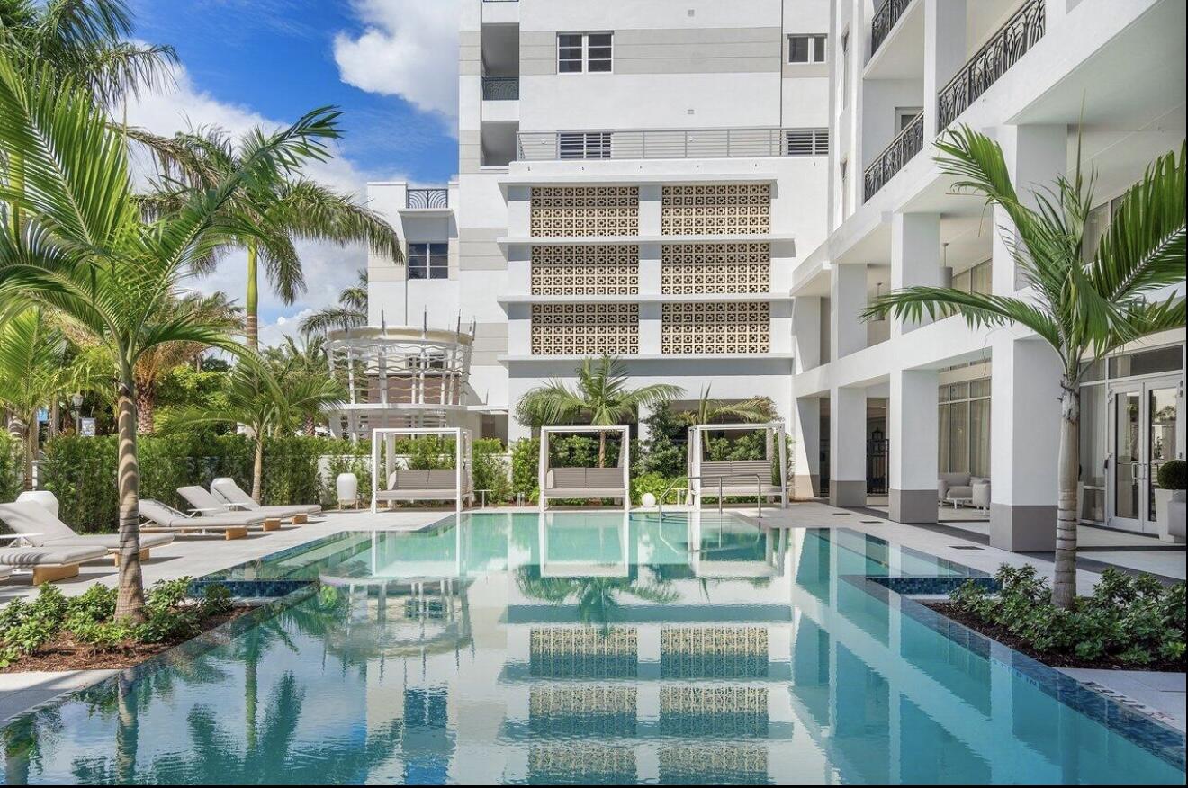 155 East Boca Raton Road, Unit 603 Boca Raton, FL 33432 - Photo 35 of 55 a view of a white building with a yard and potted plants