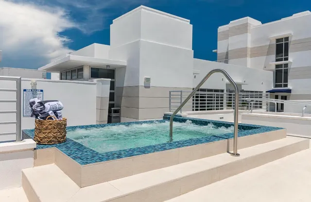 a living room with couch and a potted plant