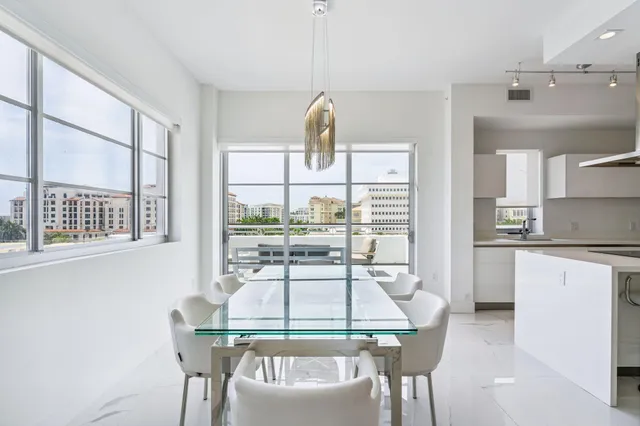 a kitchen with stainless steel appliances kitchen island granite countertop a refrigerator and cabinets