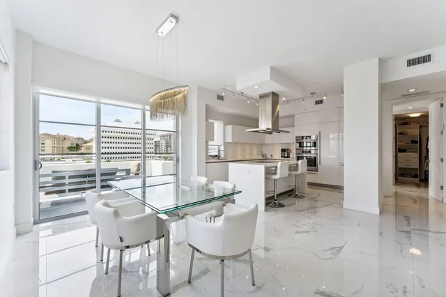 a kitchen with a sink a stove and chairs