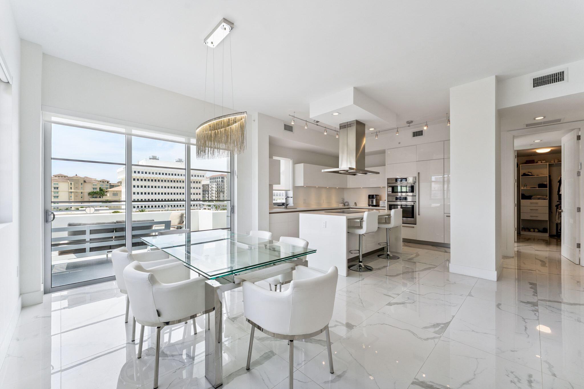 155 East Boca Raton Road, Unit 603 Boca Raton, FL 33432 - Photo 7 of 55 a kitchen with stainless steel appliances kitchen island granite countertop a refrigerator and cabinets