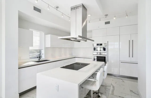a kitchen with a stove a refrigerator and cabinets