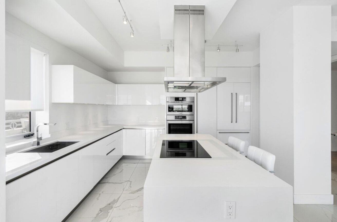 155 East Boca Raton Road, Unit 603 Boca Raton, FL 33432 - Photo 9 of 55 a kitchen with a stove a refrigerator and cabinets