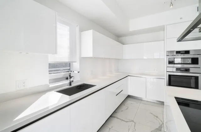 a kitchen with a sink and cabinets