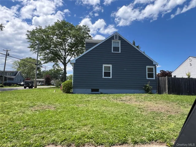 a view of a backyard with potted plants and large tree