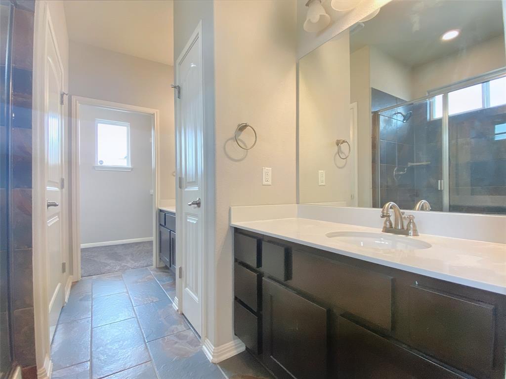 8901 Panhandle Drive Austin, TX 78747 - Photo 15 of 21 Contemporary bathroom vanity featuring a single basin, brushed nickel faucet, and white countertop