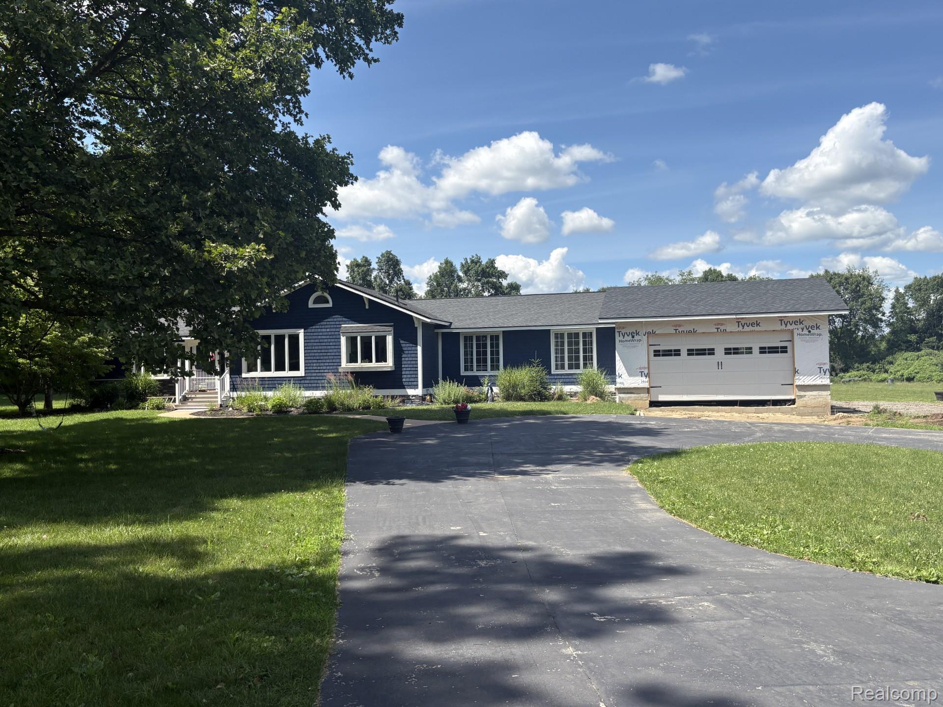 187 Darwin Road Pinckney, MI 48169 - Photo 1 of 71 Blue horizontal siding exterior with white trim and a contrasting dark asphalt shingle roof