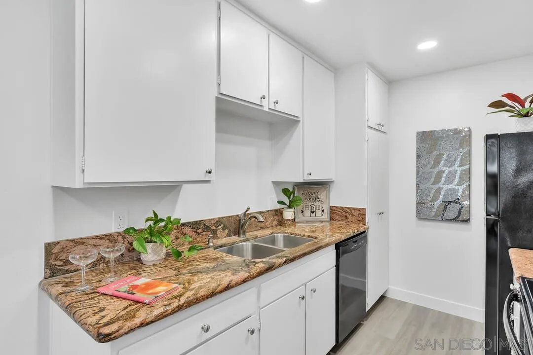 8524 Via Mallorca, Unit C La Jolla, CA 92037 - Photo 11 of 36 a kitchen with stainless steel appliances granite countertop a refrigerator sink and stove