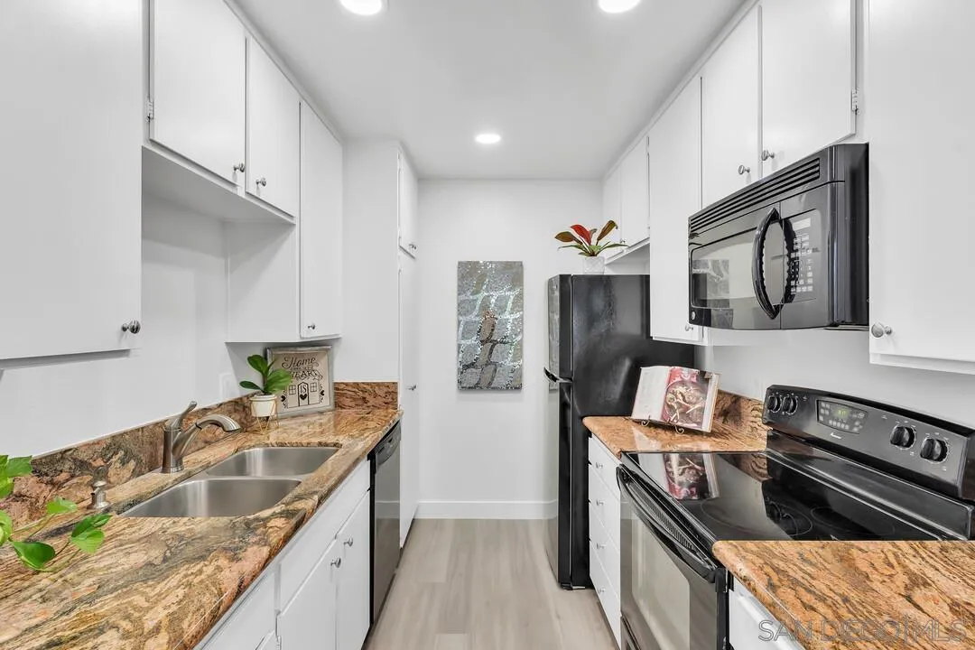 8524 Via Mallorca, Unit C La Jolla, CA 92037 - Photo 12 of 36 a kitchen with stainless steel appliances granite countertop a sink stove and refrigerator