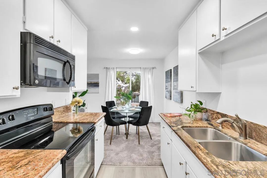 8524 Via Mallorca, Unit C La Jolla, CA 92037 - Photo 13 of 36 a kitchen with a sink stove and microwave