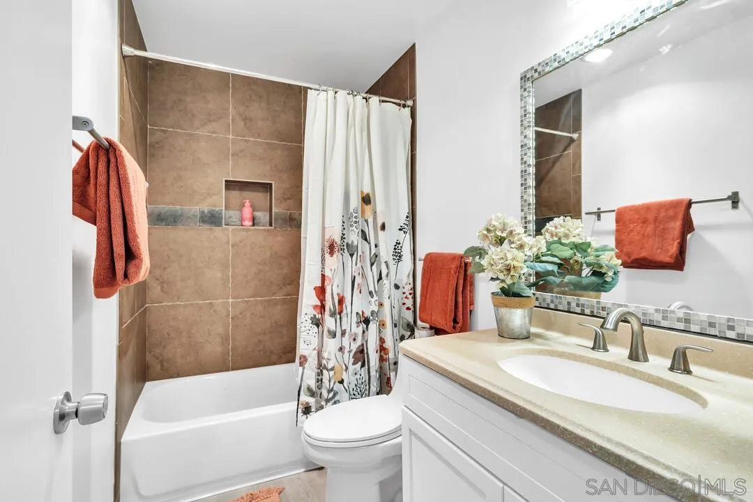 8524 Via Mallorca, Unit C La Jolla, CA 92037 - Photo 14 of 36 a bathroom with a granite countertop sink a toilet and shower