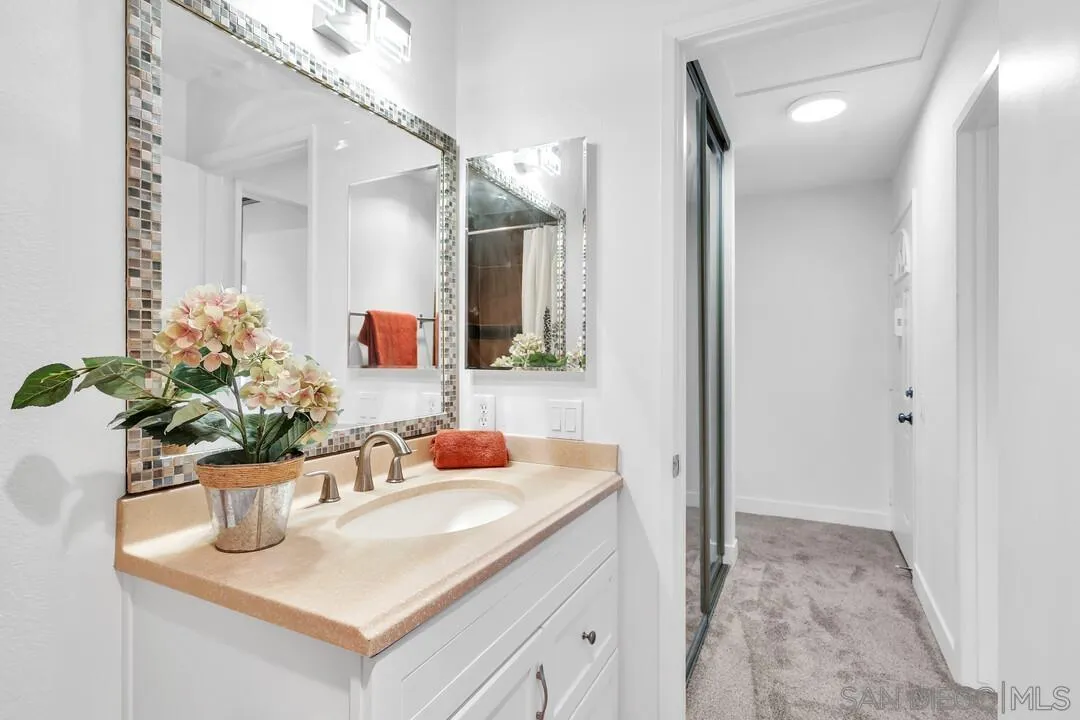 8524 Via Mallorca, Unit C La Jolla, CA 92037 - Photo 15 of 36 a bathroom with a sink and a mirror