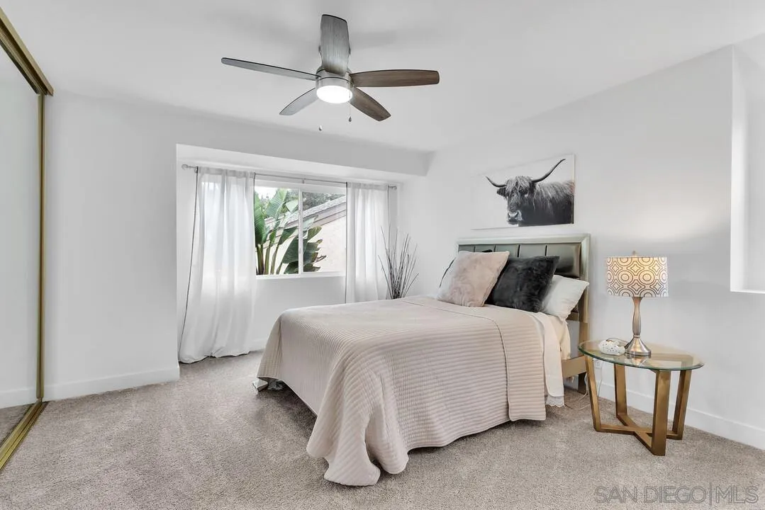 8524 Via Mallorca, Unit C La Jolla, CA 92037 - Photo 16 of 36 a bedroom with a bed and a window