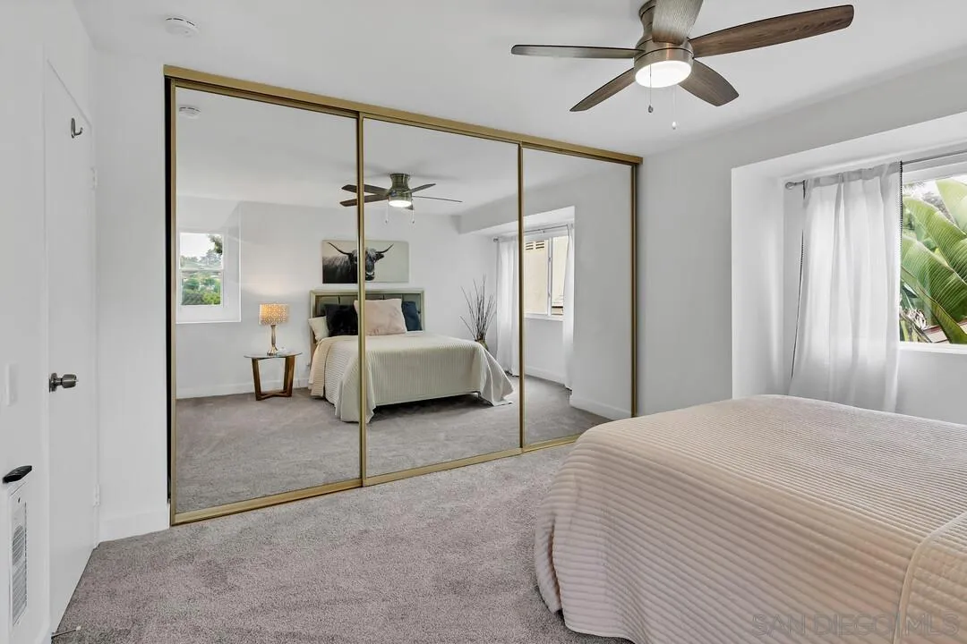 8524 Via Mallorca, Unit C La Jolla, CA 92037 - Photo 19 of 36 a living room with furniture and a chandelier