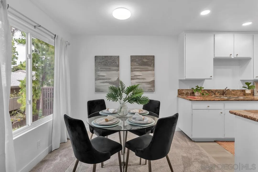 8524 Via Mallorca, Unit C La Jolla, CA 92037 - Photo 7 of 36 a view of a dining room with furniture window and outside view