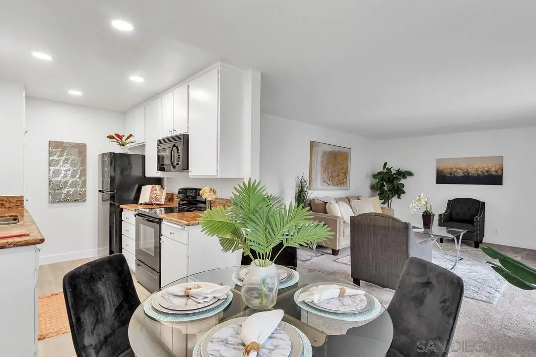 8524 Via Mallorca, Unit C La Jolla, CA 92037 - Photo 9 of 36 a dining room with furniture potted plants and wooden floor