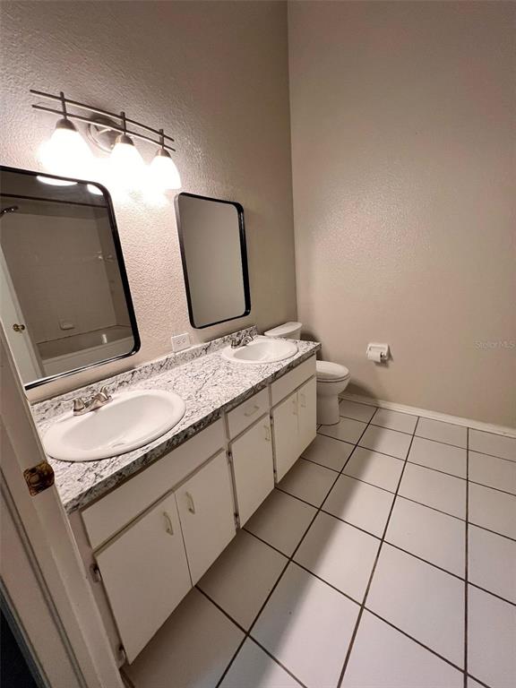 8674 Hunters Key Circle Tampa, FL 33647 - Photo 16 of 16 a bathroom with a granite countertop sink and a mirror