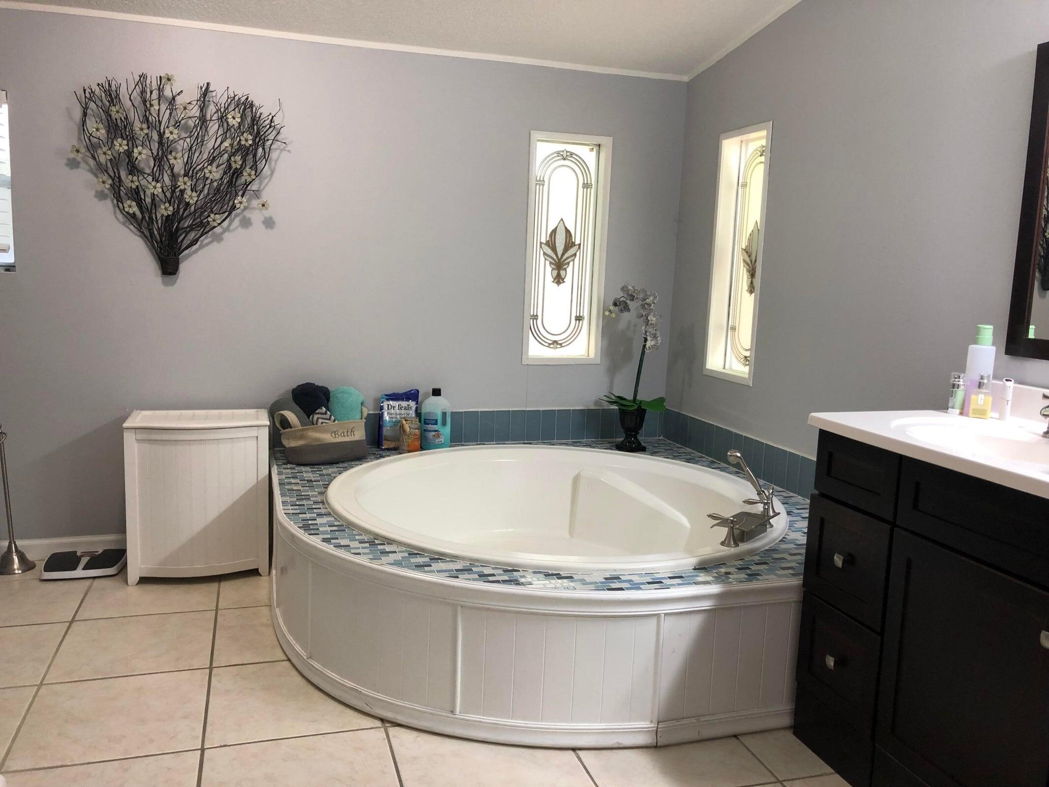 11945 Flotilla Place Boca Raton, FL 33428 - Photo 12 of 17 a white bath tub sitting in a bathroom next to a toilet
