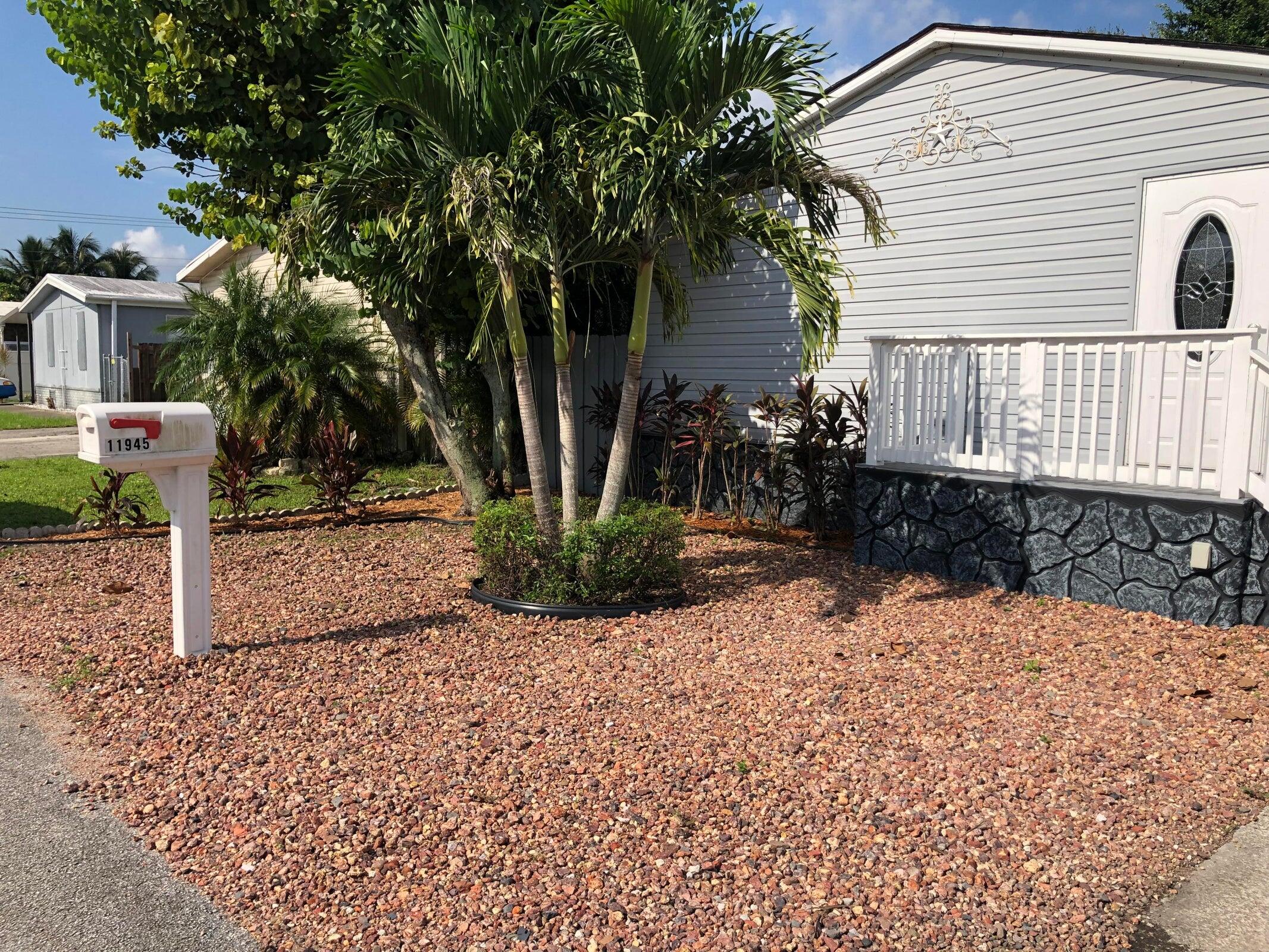 11945 Flotilla Place Boca Raton, FL 33428 - Photo 2 of 17 a view of a house with a yard