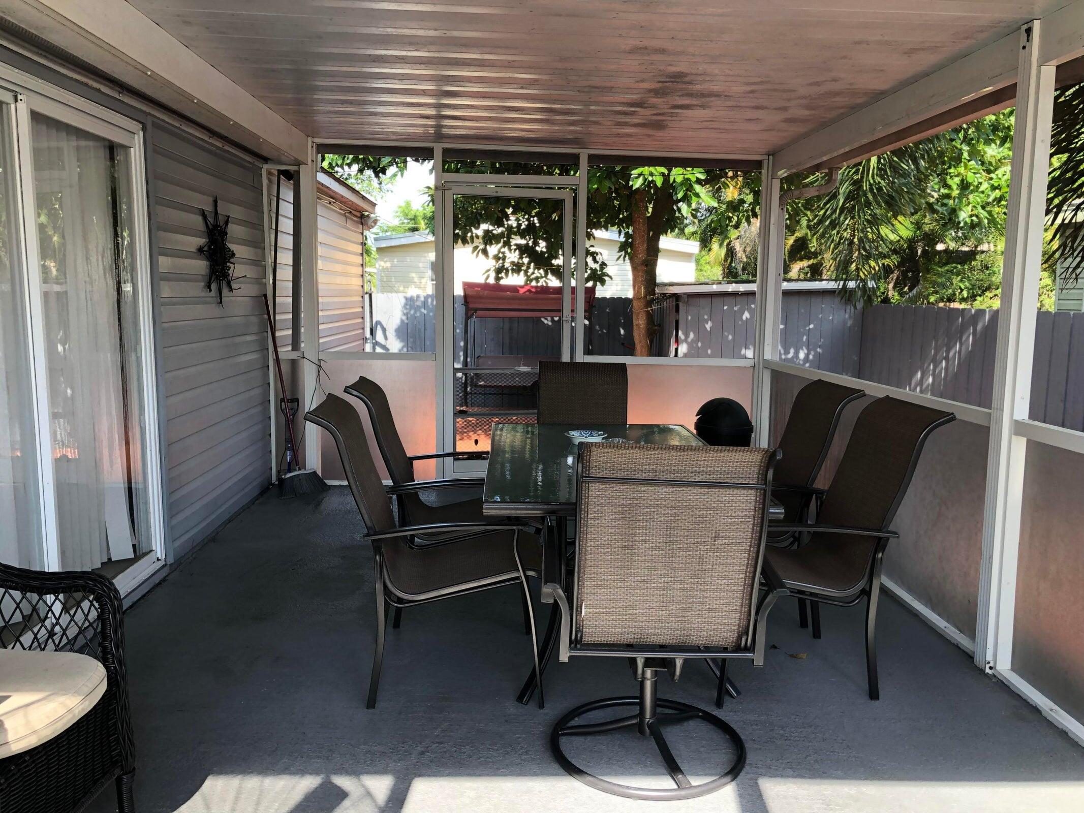 11945 Flotilla Place Boca Raton, FL 33428 - Photo 9 of 17 a view of a porch with furniture and a backyard