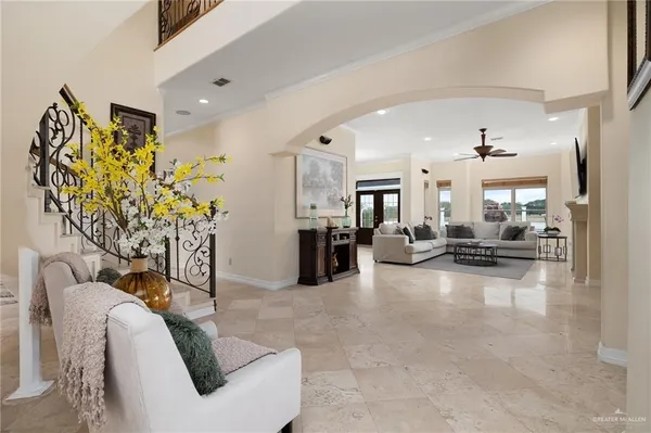 a living room with furniture a fireplace and a flat screen tv