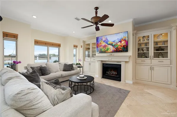 a kitchen with kitchen island granite countertop a sink stove cabinets and refrigerator