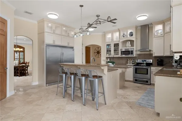 a kitchen with stainless steel appliances granite countertop a sink stove and cabinets