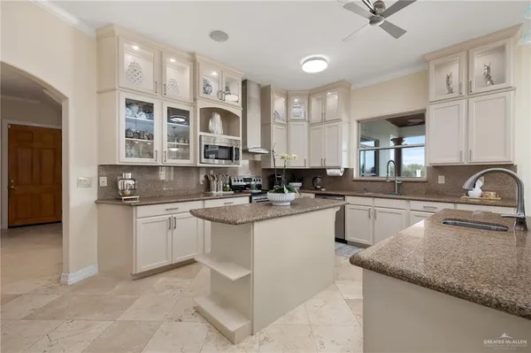a kitchen with stainless steel appliances granite countertop a sink stove and cabinets