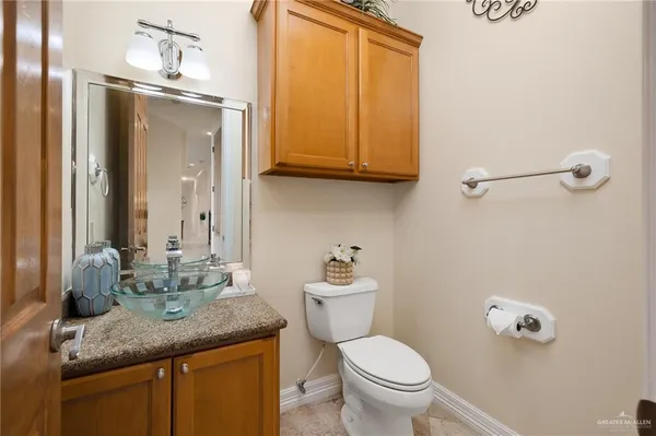 a spacious bedroom with a bed a window and a flat screen television