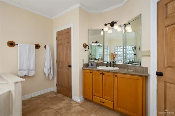 a bathroom with a tub sink and mirror