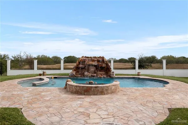 a view of a swimming pool with an outdoor seating and a yard