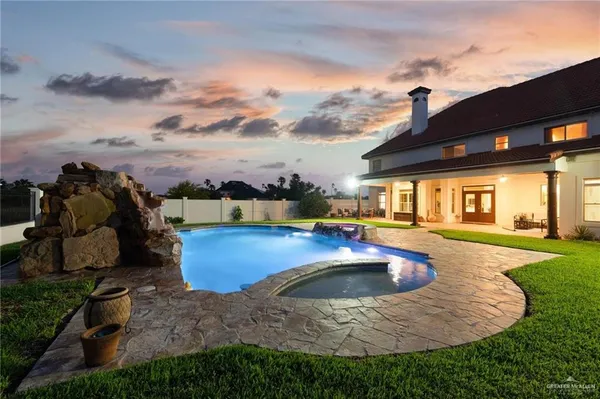 a view of a house with swimming pool and sitting area