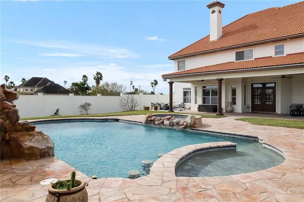 a view of house with yard and sitting area