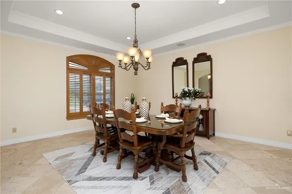 a view of a dining room with furniture and chandelier