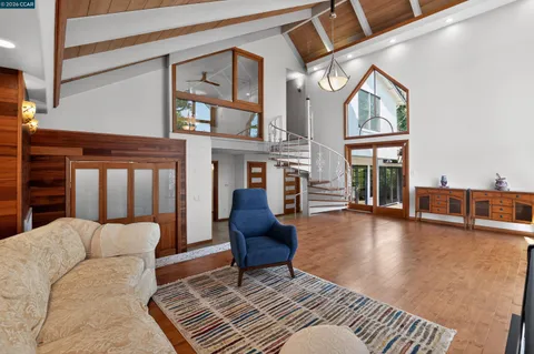 a kitchen with stainless steel appliances granite countertop a stove a sink a oven a dining table and chairs