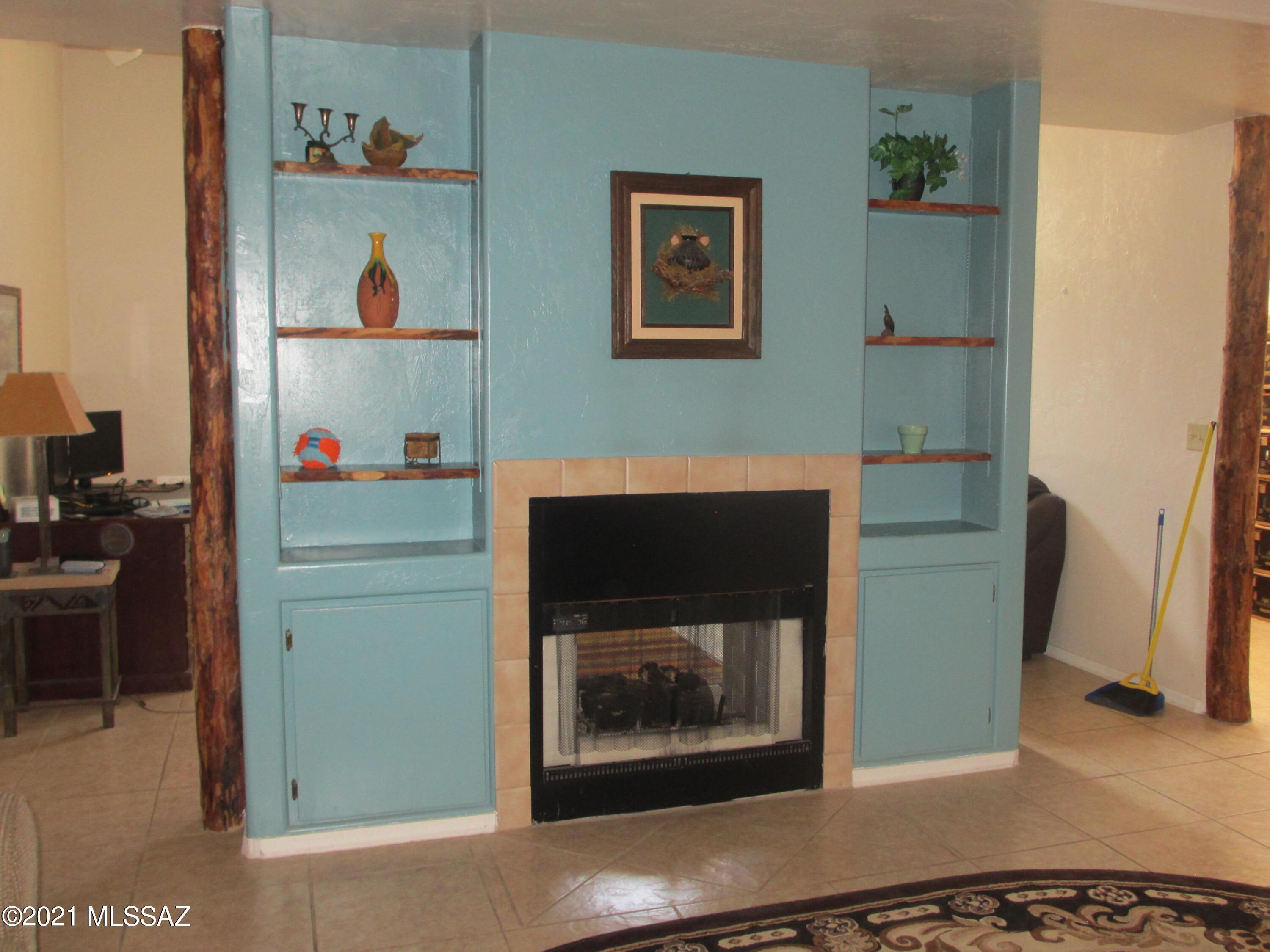 978 Calle Amarillo Rio Rico, AZ 85648 - Photo 28 of 34 a room with a fireplace and cabinets