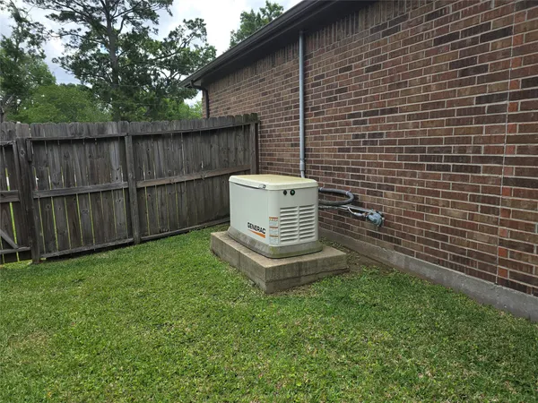 a view of a backyard with wooden fence