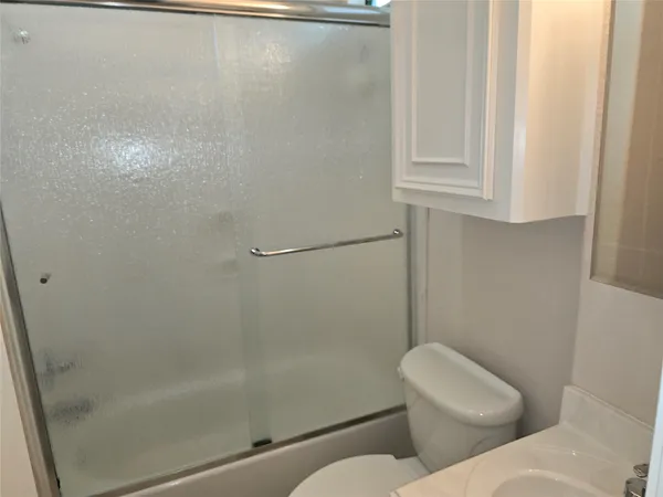 a bathroom with a toilet and a shower