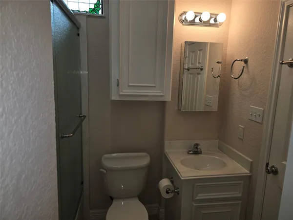 a bathroom with a sink toilet and vanity