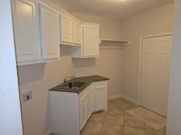 a kitchen with a sink and cabinets