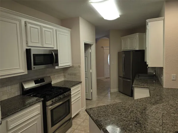 a kitchen with a stove microwave and refrigerator