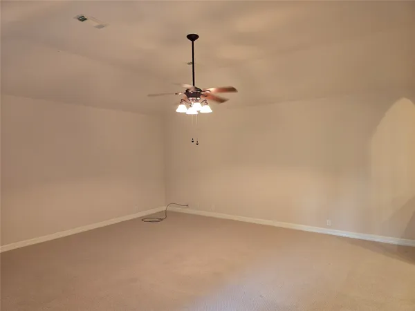 a view of a room with a hanging light and kitchen