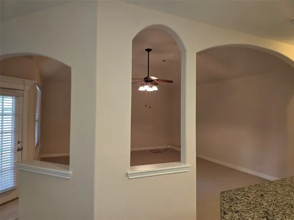a view of a room that has a glass door and painted walls