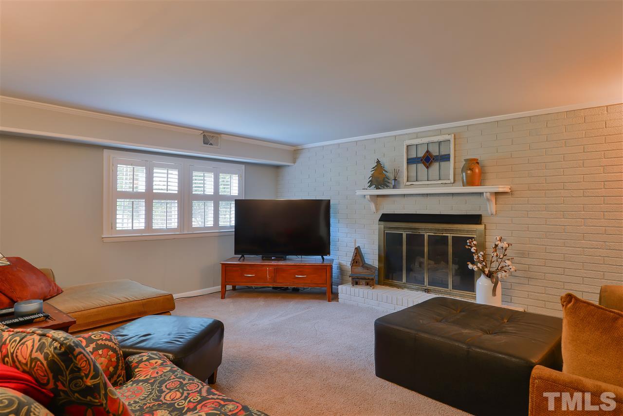 303 Glen Valley Road Raleigh, NC 27609 - Photo 12 of 24 a living room with furniture and a flat screen tv