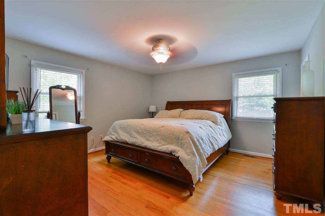 303 Glen Valley Road Raleigh, NC 27609 - Photo 14 of 24 a bedroom with a bed and a potted plant on the dresser