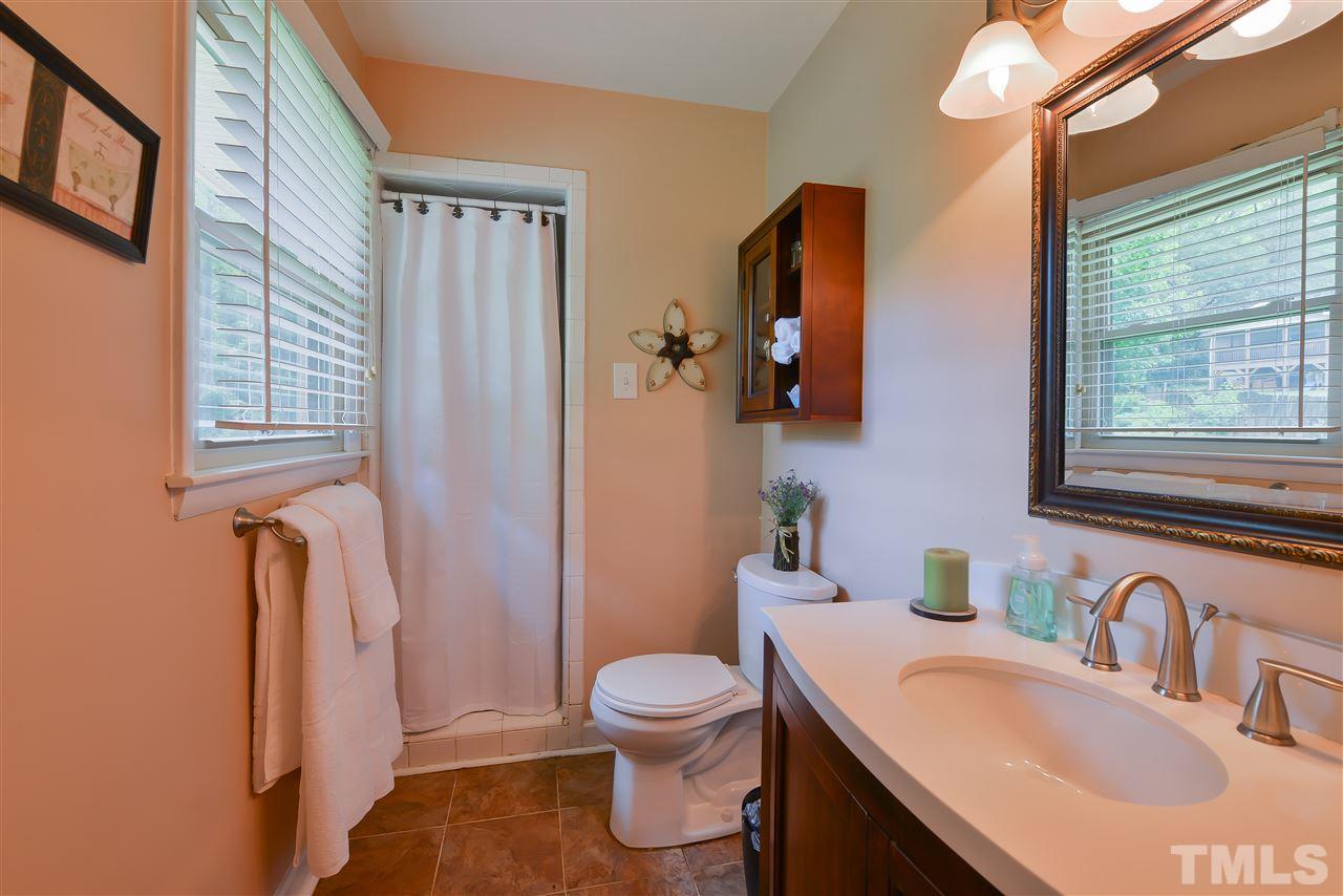 303 Glen Valley Road Raleigh, NC 27609 - Photo 15 of 24 a bathroom with a sink toilet tub and mirror