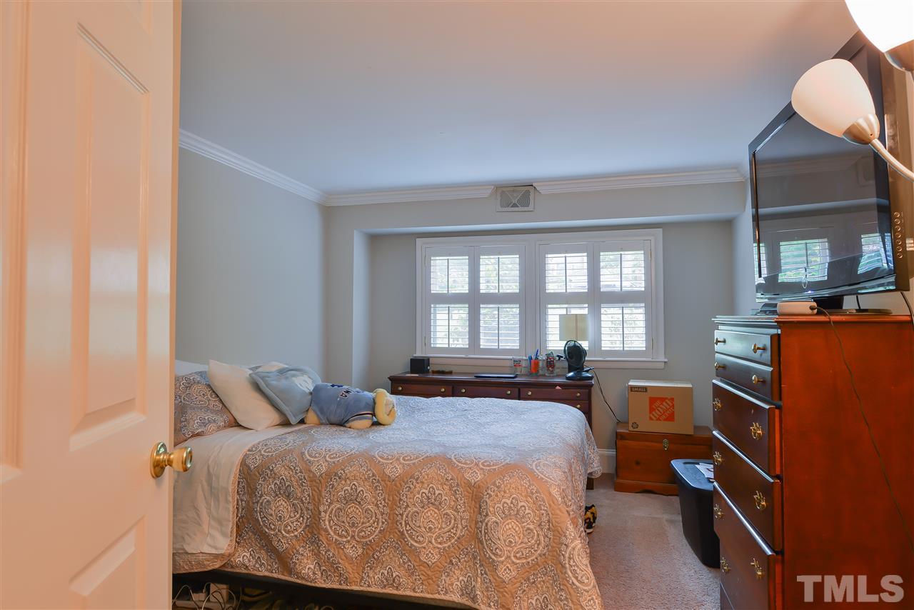 303 Glen Valley Road Raleigh, NC 27609 - Photo 16 of 24 a bedroom with a bed and wooden floor