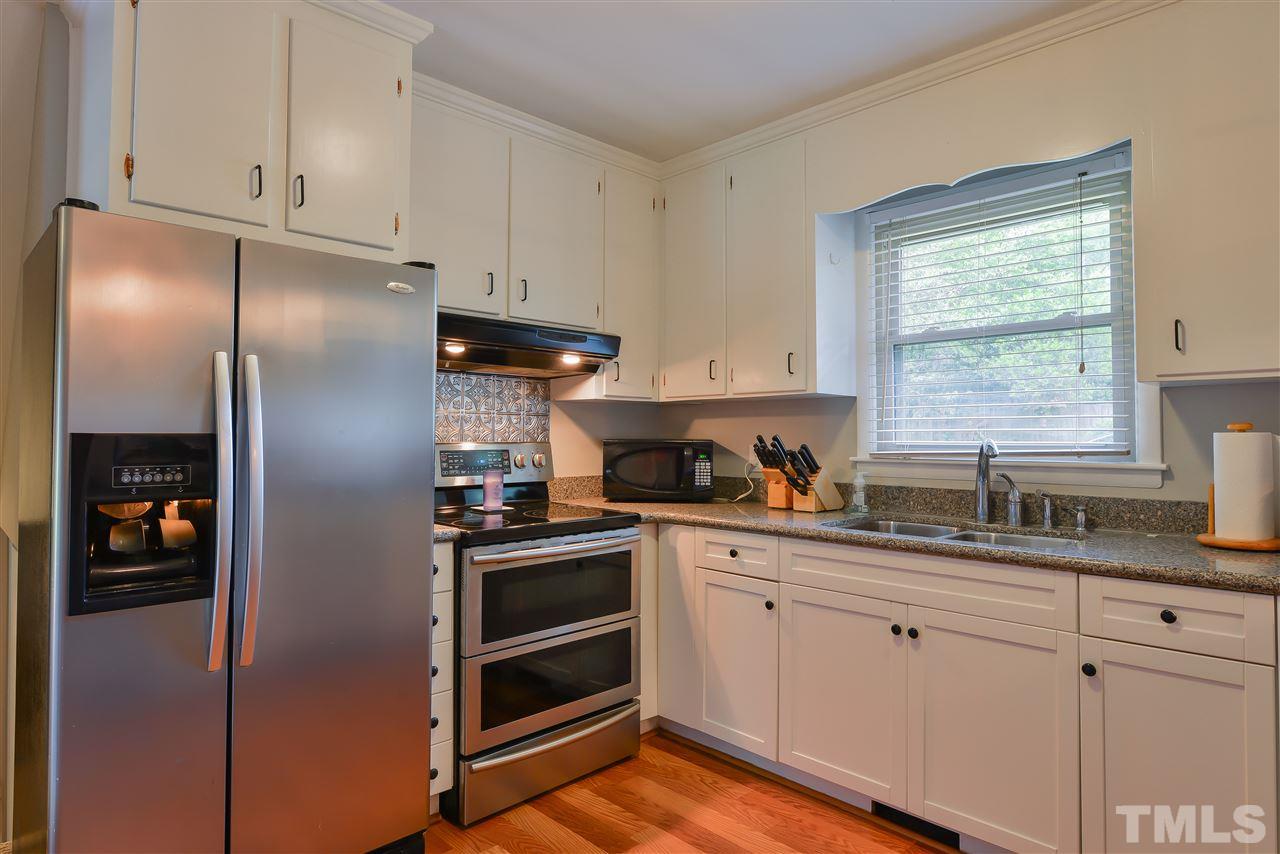 303 Glen Valley Road Raleigh, NC 27609 - Photo 8 of 24 a kitchen with stainless steel appliances cabinets and a window