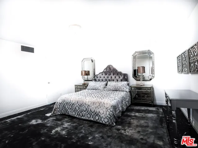 a view of a livingroom with furniture and an empty room