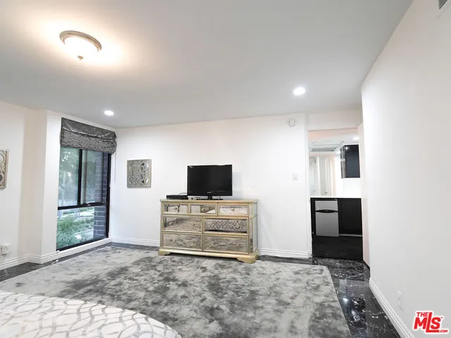 a large bathroom with a granite countertop sink a mirror and shower
